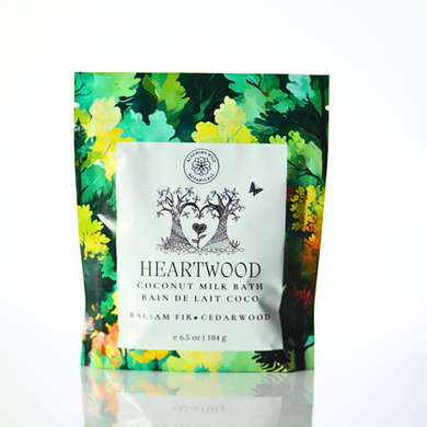 Heartwood coconut milk bath package with colorful leaf design on a white background