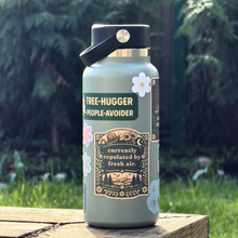Water bottle with a humorous label in a natural setting