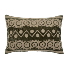 Olive green decorative pillow with embroidered geometric pattern on a white background