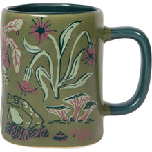 Mug with floral and frog design on a green background