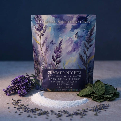 Coconut milk bath product with 'Summer Nights' label surrounded by lavender and leaves on a dark background