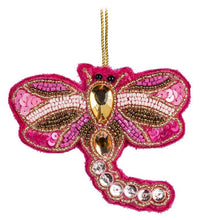 Pink beaded dragonfly ornament on white background