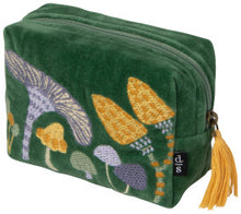 Green velvet pouch with mushroom embroidery and a yellow tassel on a white background