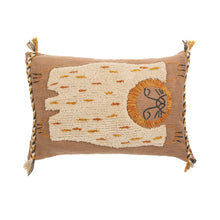 Decorative pillow with woven pattern and tassels on a white background