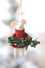 Felt mouse in red sweater holding a bough of greens on white background