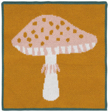 Knitted mushroom design on a square dishcloth with a ochre background and teal border