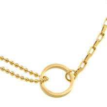 Gold necklace with a circular pendant on a white background