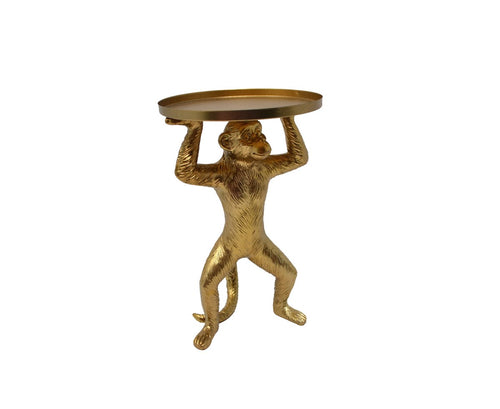 A gold monkey shaped t lite holder on a white background