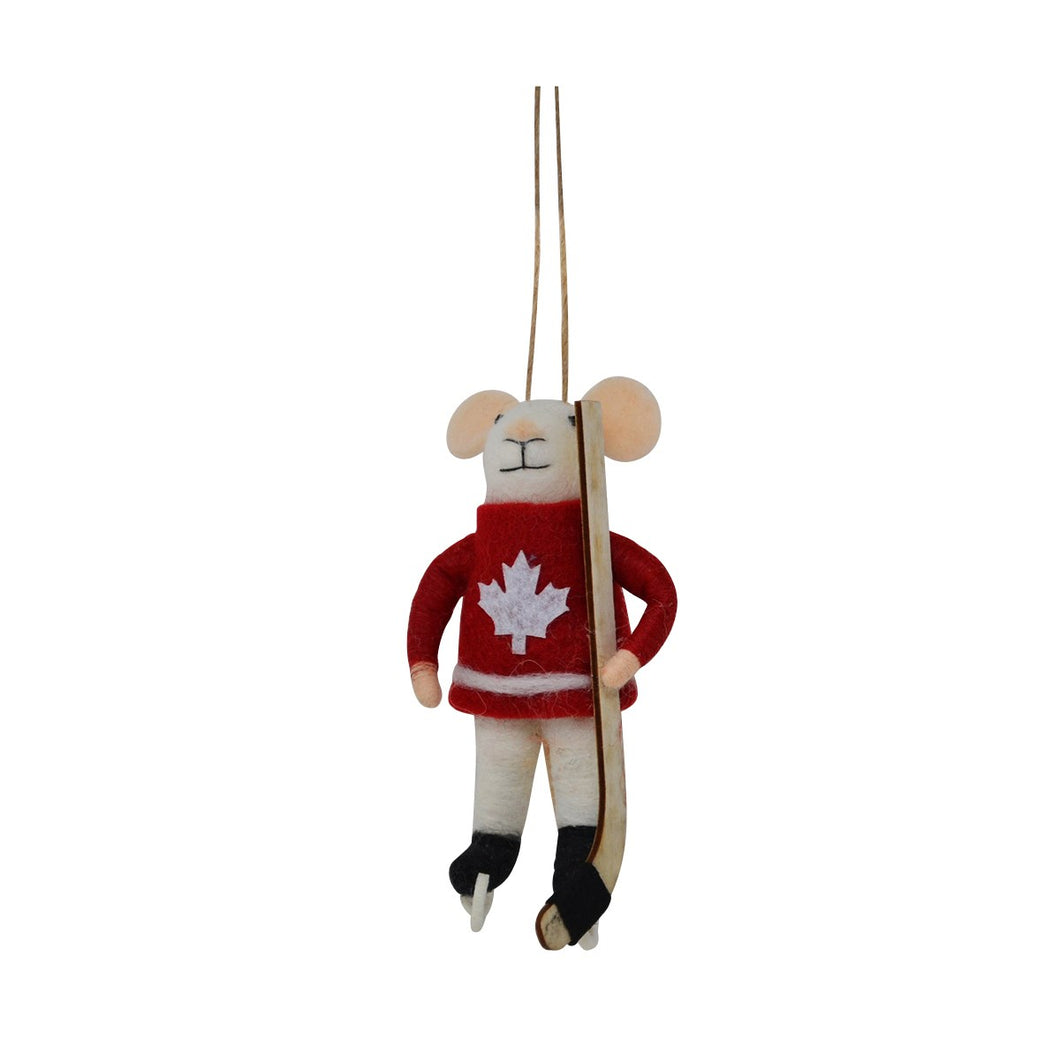 A small felt mouse hanging ornament dressed in a red sweater with a white maple leaf, white pants, and skates, holding a hockey stick, shown against a plain white background.