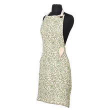 Cotton apron with green floral pattern, pockets and adjustable strap