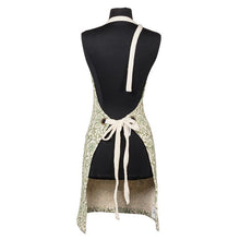 Cotton apron with green floral pattern, pockets and adjustable strap