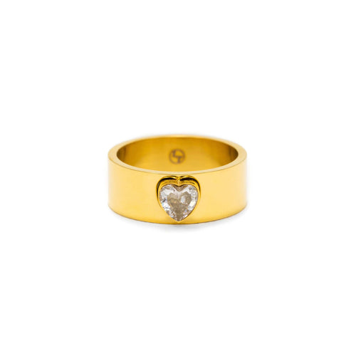Gold ring with a heart-shaped gemstone on a white background