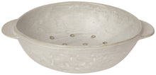White ceramic colander with handles on a white background