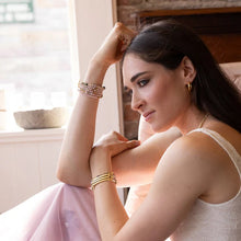 Woman sitting indoors with a soft, warm background