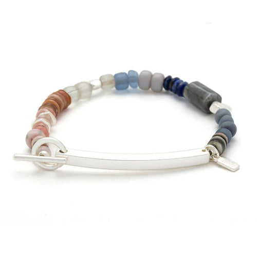 Multicolored beaded bracelet with a silver clasp on a white background
