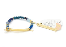 Bracelet with blue and gold elements on a white background