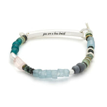 Beaded bracelet with a silver bar and 'you are a boss bitch' engraving on a white background