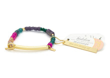 Colorful beaded bracelet with a gold bar and tag on a white background