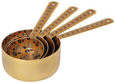 Set of gold measuring cups with floral patterns on a white background