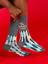 Person wearing patterned socks with text on a red background