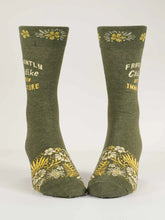 Grey socks with yellow text and floral patterns on a white background