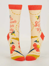 Pair of socks with floral design and text on a white background