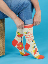 Person wearing knee-high socks with floral design and text on a blue background