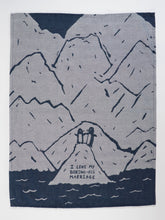 Textile with mountain design and text 'I love my boring-ass marriage' on a blue and gray background
