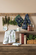 Wooden shelf with books, plants, and decorative items against a beige wall.