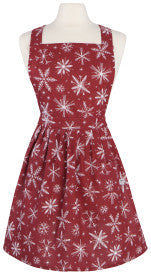 Red apron with white snowflake pattern on a mannequin against a white background