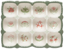 Decorative egg holder with floral patterns on a white background