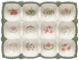 Decorative egg holder with floral patterns on a white background