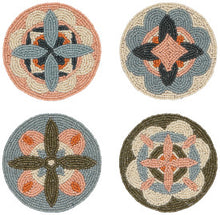 Set of four round beaded coasters with floral patterns on a white background