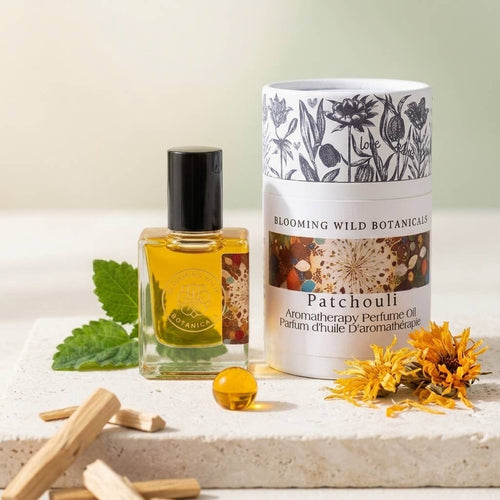 Aromatherapy perfume oil bottle and packaging with flowers and leaves on a light background