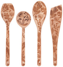 Set of four wooden spoons with floral patterns on a white background