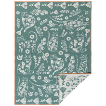 Teal dishtowel with white cat and floral pattern