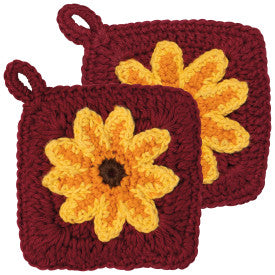 Two maroon crochet dish scrubbers with yellow flower designs on a white background