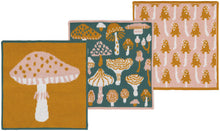 Three mushroom-themed dishcloths on a white background