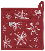 Red pot holder with white snowflake patterns on a red background