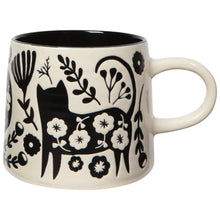 Ceramic mug with black and white floral and cat design on a white background