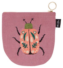 Pink pouch with a beetle design on a white background