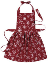 Red apron with white snowflake pattern on a plain background