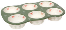 Muffin tin with floral design on a green background